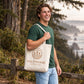Man carrying the Saltwood Coffee Co. natural tote bag outdoors